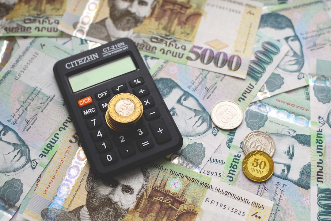 Armenian paper money banknotes and coins and calculator on the table.