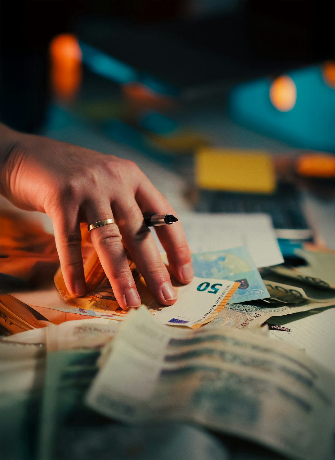 Euro Banknotes Contract Signature Financial Agreement Budget close-up view male hand signing contract beside scattered euro bills